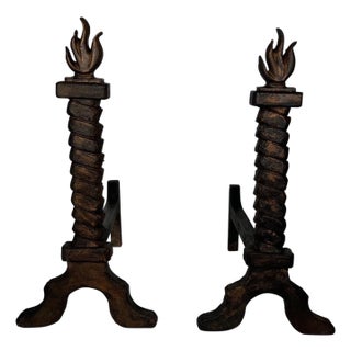 Pair of cast iron and wrought iron firedogs, flame-gilded, in the style of Gilbert Poillerat For Sale