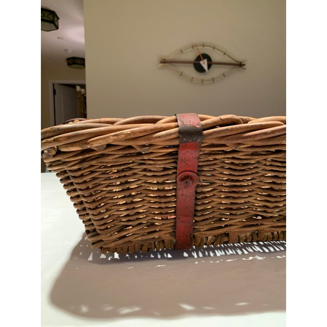 Antique rustic French kindling basket with metal strapping. It is sturdy and elegant in its simplicity