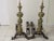 Pair of monumental andirons, brass and iron, late 19th-early 20th century. 31.5" height; 16" width; 29" depth; the...