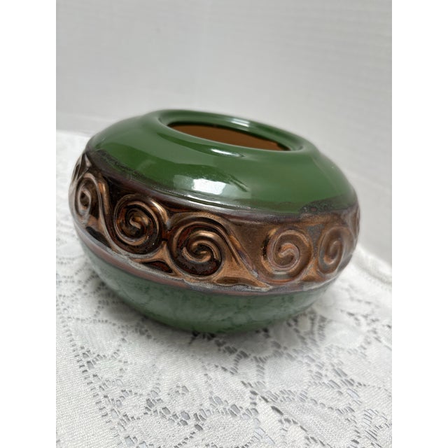 Vintage green ceramic pottery plant vessel with textured bronze patterned design. Simple elegance for indoor or outdoor use.