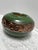 Vintage green ceramic pottery plant vessel with textured bronze patterned design. Simple elegance for indoor or outdoor use.