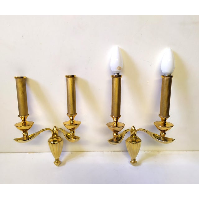 These two wall lamps were made in Italy around 1950 and represent a rare example of spoon-shaped brass casting. Excellent...