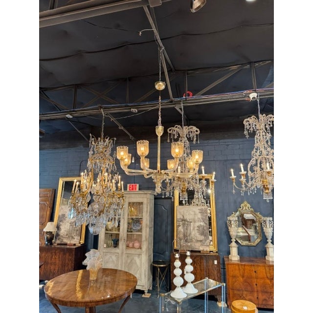 The Modernist Gold Murano Glass and Brass 8 Light Chandelier is a stylish and unique ceiling fixture that adds a touch of...