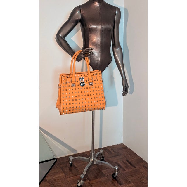 Compare to Michael Kors North South Hamilton tote. This bag does not have a maker anywhere visible but has a crown on the...