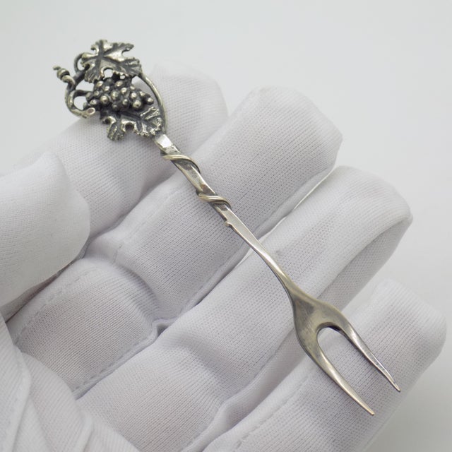 An inviting touch of Tuscan hospitality for your bar cart or entertaining table, this solid silver miniature cocktail fork...