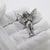 This vintage silver relief figurine depicts a guardian angel (angelo), designed with a reverse hook for wall hanging....