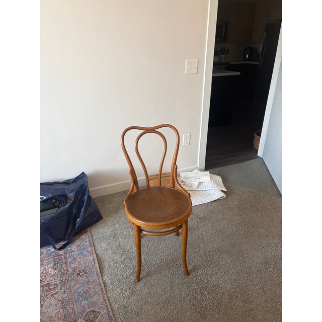 Authentic Thonet bentwood side chair featuring the original Thonet Wien paper label and an embossed wood seat with...