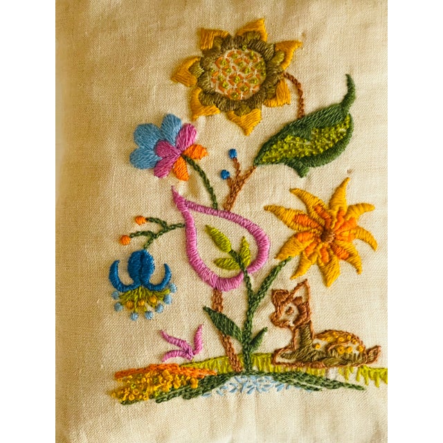 Lovely pair of antique crewel embroidered floral lumbar linen pillows with a dog and squirrel.
