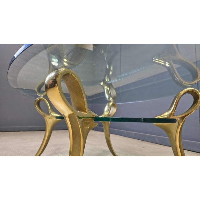 Elegant 4 legged solid brass coffee table with two tier clear glass tops. Beautiful piece, timeless and will combine in...