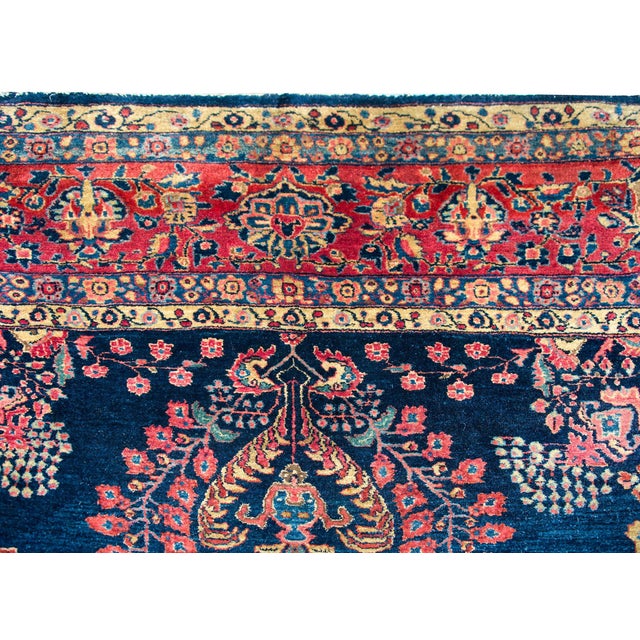 An incredible early 20th century Persian Sarouk Mohajeran rug with a typical large-scale mirrored floral pattern woven in...