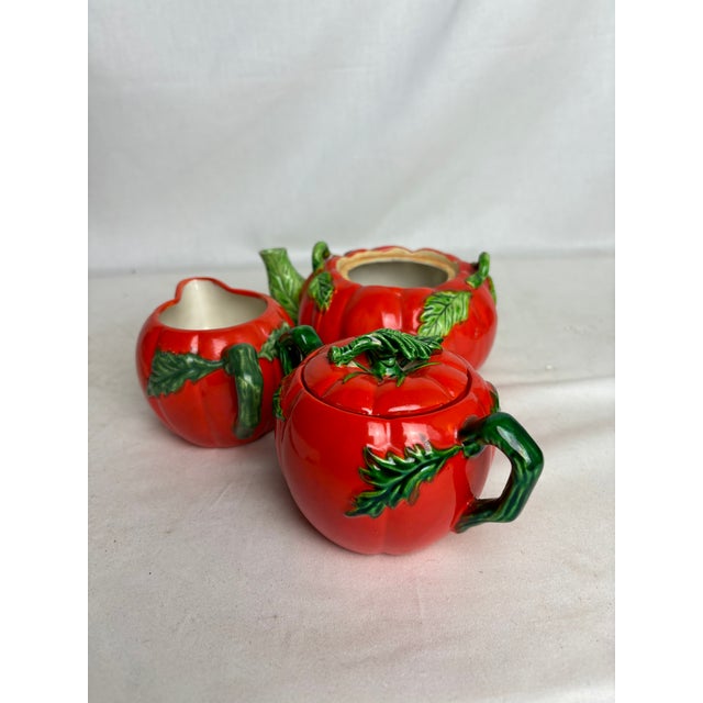 This lovely hand painted pumpkin tea set is a beautiful way to brighten up a space. The lid from the tea pot is missing...