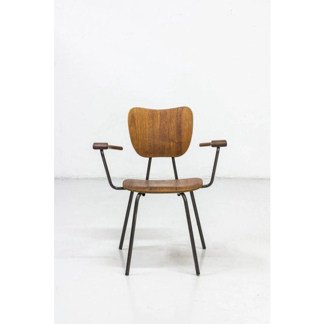 Armchair made in sweden during the 1950-60s. Made from tubular steel with black lacquer, laminated teak seat and backrest....