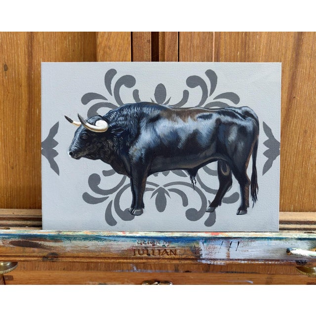 This oil painting presents a striking profile of a bull, rendered in rich, deep blacks that emphasize its muscular form...