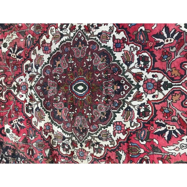 Nice mid-20th century rug with beautiful floral design and red, blue, green and pink colors, entirely hand knotted with...