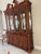 Traditional style China cabinet and hutch. Beautiful detail carving and lion ring handle accents. It has two glass shelves...