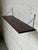 This sleek wall-mounted shelf features rich grain patterns and minimalist lines, exemplifying Scandinavian design. The...