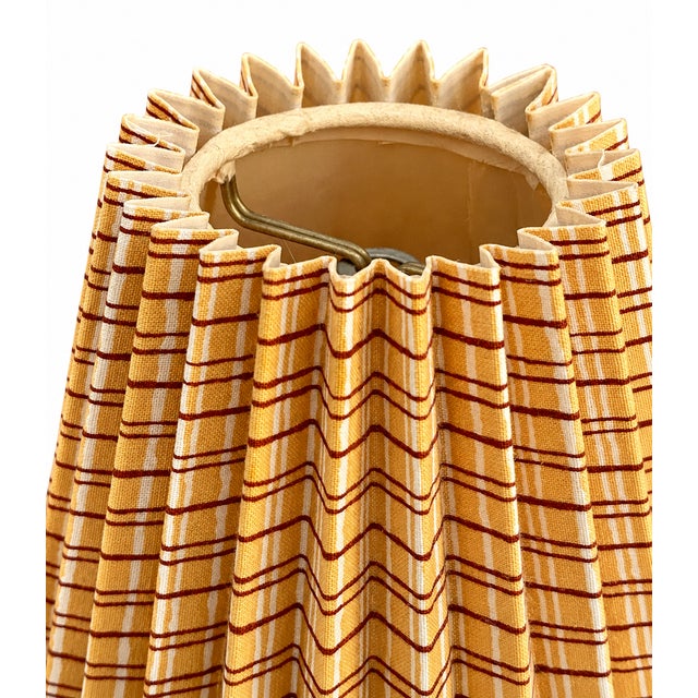 A charming pair of mid-century pleated fabric lampshades, dating to approximately the late 1950s–early 1960s. The shades...