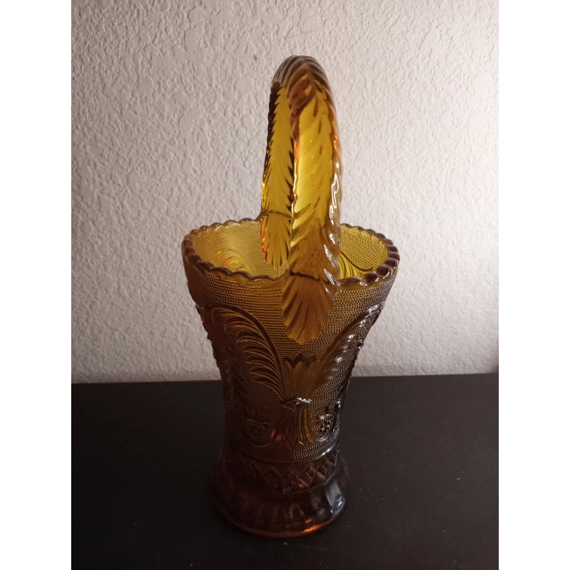 This is a vintage 1960 Indiana Glass Tiara Sandwich Amber Glass 10" Top Handle Basket Vase. Procured at auction BOX 23