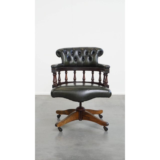 This dark green cowhide and wooden height-adjustable, swivel and tilt chesterfield office chair. This graceful and fun...