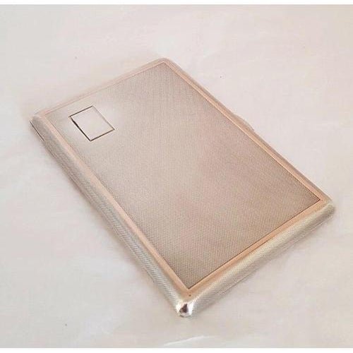 A handsome george vi sterling silver cigarette case, hallmarked birmingham 1945 and made by w. H. Manton ltd. The exterior...