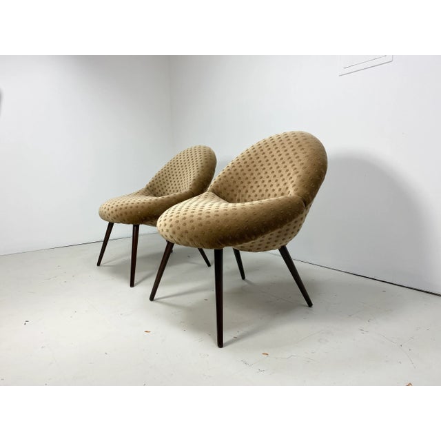 Petit pair of 1950’s “cocktail“ chairs. Made in Germany. Stained wood legs.