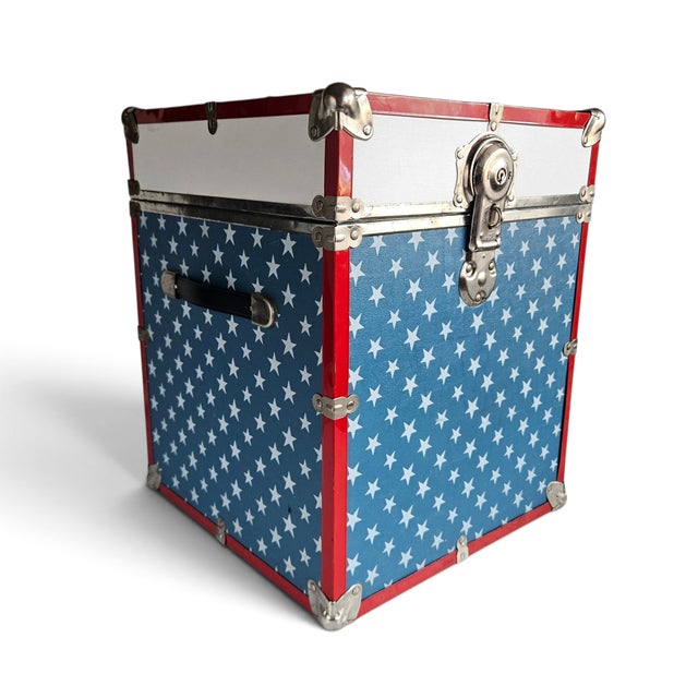 A vibrant vintage 1970s steamer trunk footlocker featuring an iconic patriotic American flag stars-and-stripes motif....