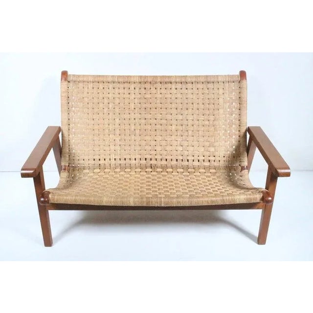 Mexican Modern Michael van Beuren teak and woven raffia lounge settee. Featuring a sturdy, functional, with comfortable...