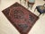 An early 20th century Persian Farahan Sarouk area rug in a classic medallion pattern of refined elegance. Hand-knotted...