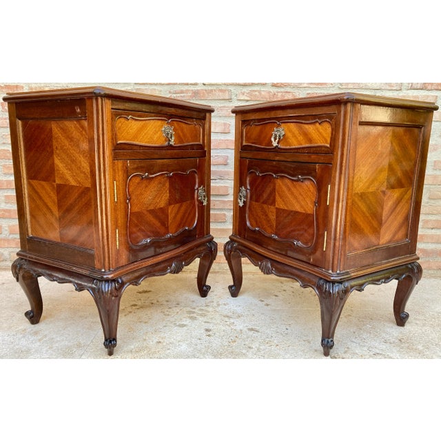 Pair of early 20th Century Louis XV style French walnut bedside tables. This pair of French 'tables de chevet' was created...
