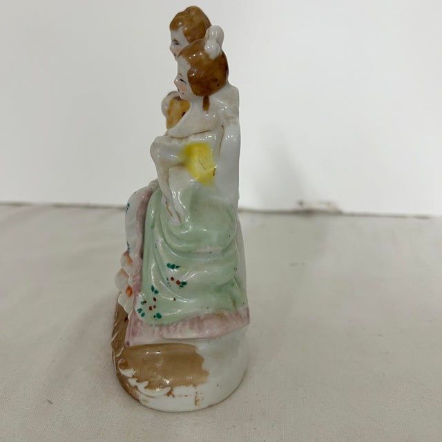 Courting couple figurine marked Occupied Japan. Measures 4” w x 2” d x 5” h.