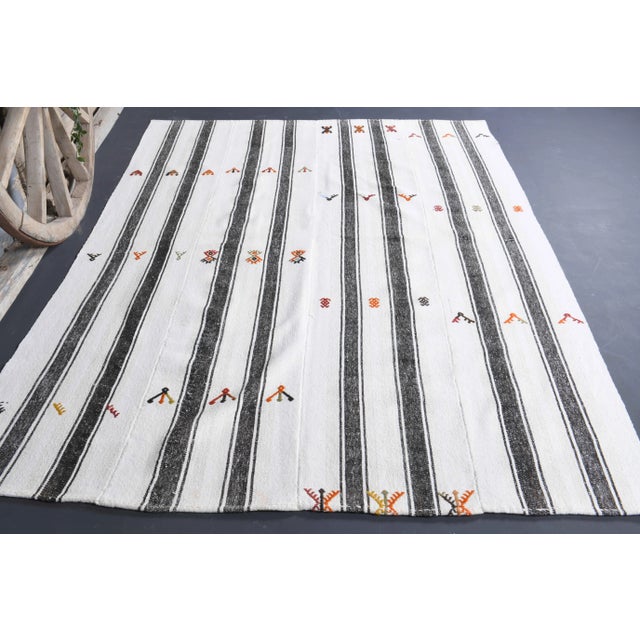 Vintage Turkish Hand-Knotted vintage rug is a semi-Vintage kilim area rug.'70s Eastern region of Turkey's unique rug is...