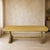 A striking long, low vintage sofa table in a softly timeworn butter-yellow painted finish. The rectangular top is...
