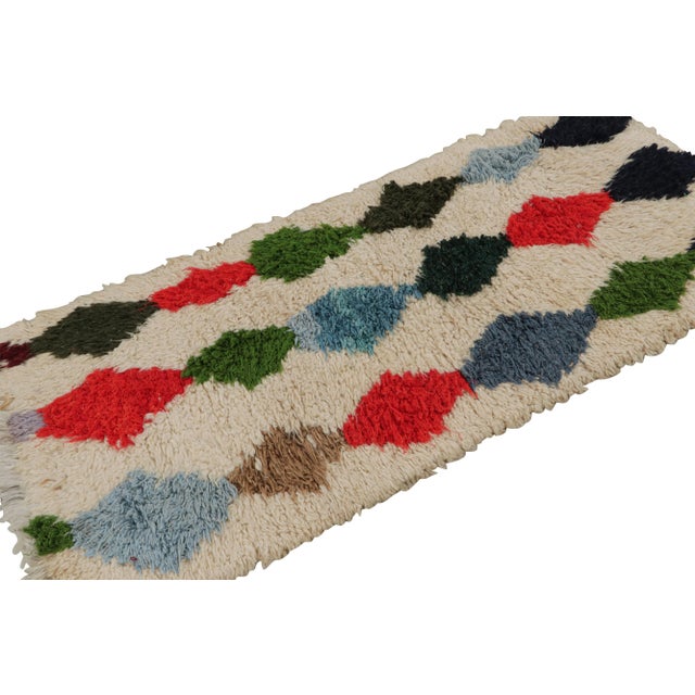 Hand-knotted in wool circa 1950-1960, this 2x6 vintage Moroccan runner rug in beige, with polychromatic diamond patterns,...