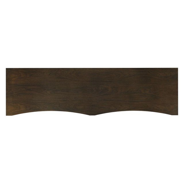 An ample storage chest with a double concave front with six individual drawers mounted with cast brass ring pulls elevated...