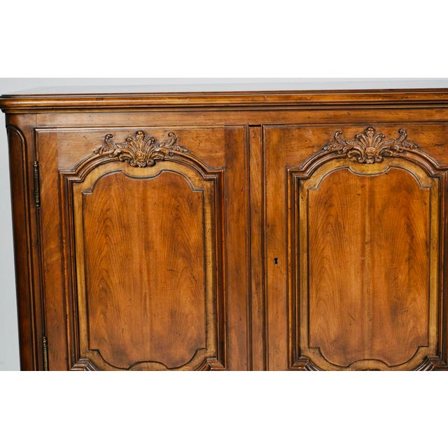 A substantial and beautifully crafted French Provincial style walnut buffet by Baker Furniture, dating to approximately...