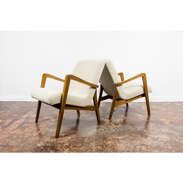 A pair of armchairs type 300-138, manufactured by Bystrzyckie Fabryki Mebli in the 1960s. The armchairs have been...