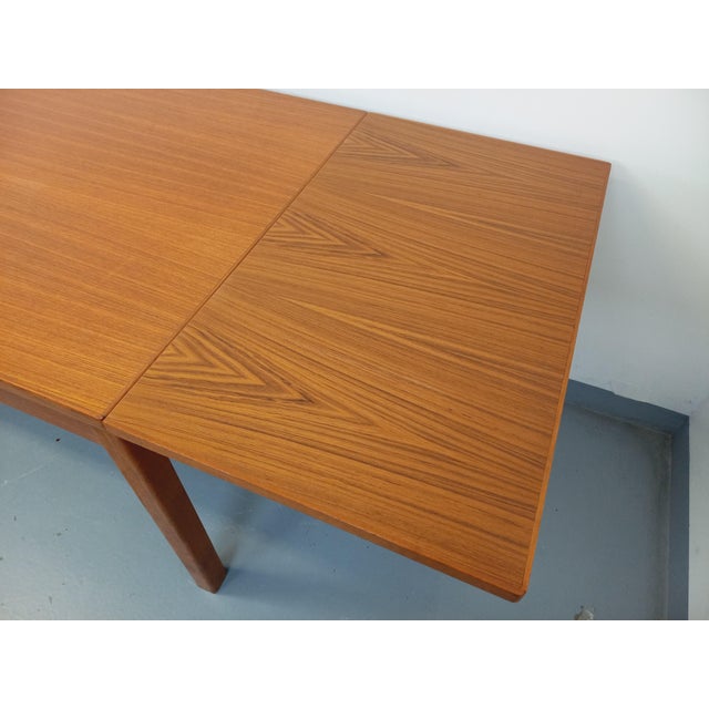 Vintage rectangular dining table from the 60s, in teak, rectangular top, with two integrated extensions at the ends,...