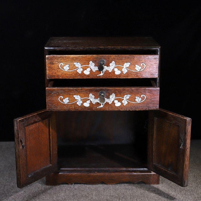 This is a magnificent vintage Chinese Huali (Rosewood) tabletop cabinet, exquisitely decorated with Mother-of-Pearl (MOP)...