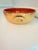 Handcrafted vintage ceramic centerpiece bowl featuring a warm ochre exterior with expressive dark brushwork and a striking...