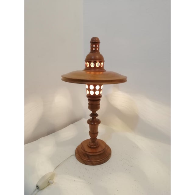 Table lamp made entirely of boxwood with a modernist design. Crafted with exquisite detail. The holes allow light to shine...