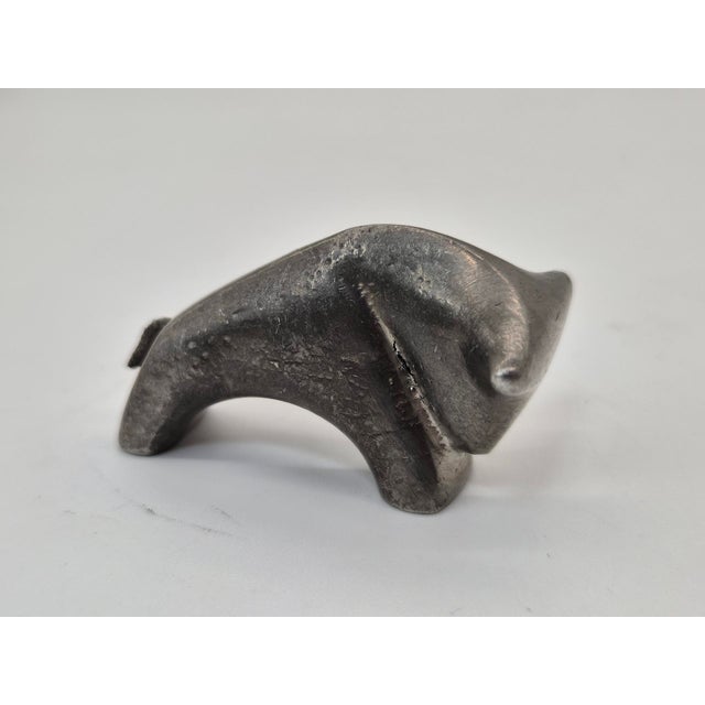 An original miniature animal figurine with a sculptural, highly simplified form. Made of heavy metal, likely a solid cast,...