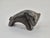 An original miniature animal figurine with a sculptural, highly simplified form. Made of heavy metal, likely a solid cast,...