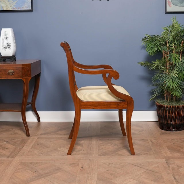 This fine quality set of ten Lyre Chair or Harp Back Chairs by Niagara Furniture consist of 2 arm chairs and eight side...