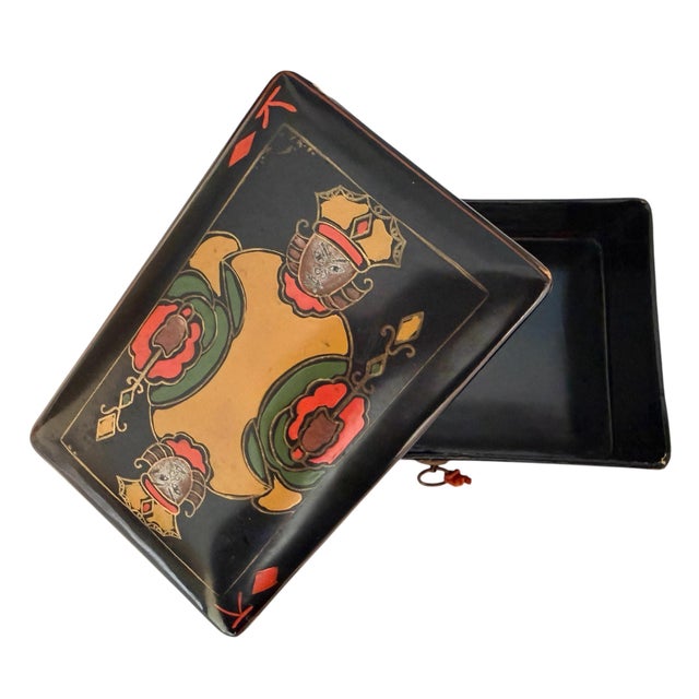 Lacquered black papier mache box to hold playing cards. Hand painted king of diamonds playing card on the front.