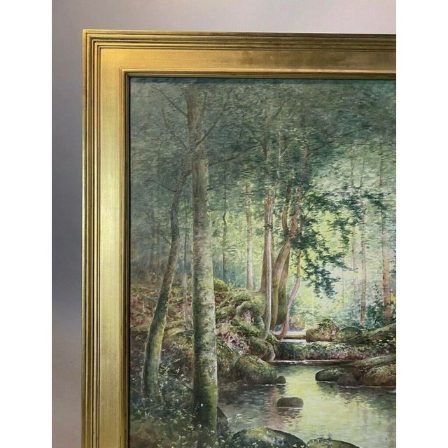 Antique Arts & Crafts realistic watercolor painting of forest landscape with stream and trees seated in gilt wood frame...