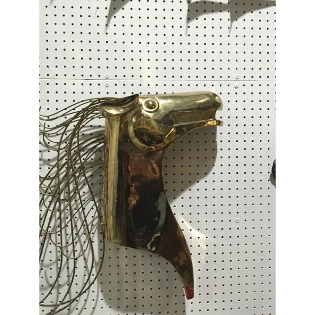 Curtis Jere wall sculpture of gold horse. This piece is signed on a rod of the mane with C. Jere 1984, brass wall...