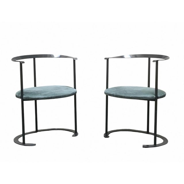 Catilina chair with painted steel frame, black lacquered plywood seat, and polyurethane cushion covered in green fabric....