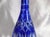 This is a tall blue cut to clear bottle or decanter with no stopper. I have not found any markings on it and the bottom is...