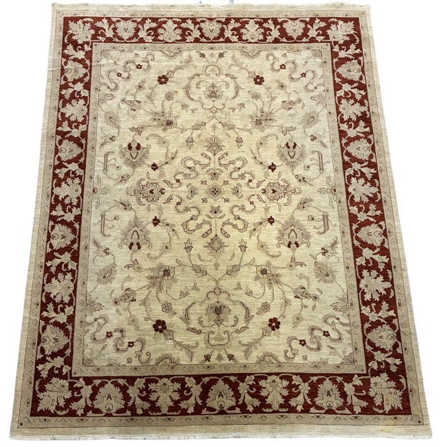 A large hand-knotted area rug featuring an elegant Oushak-inspired floral design in a warm, understated palette. The soft...