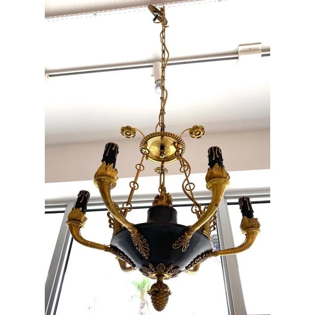 Antique Early 19 Century French Empire Chandelier in Patinated Bronze and Gold Dore This stylish French Empire chandelier...